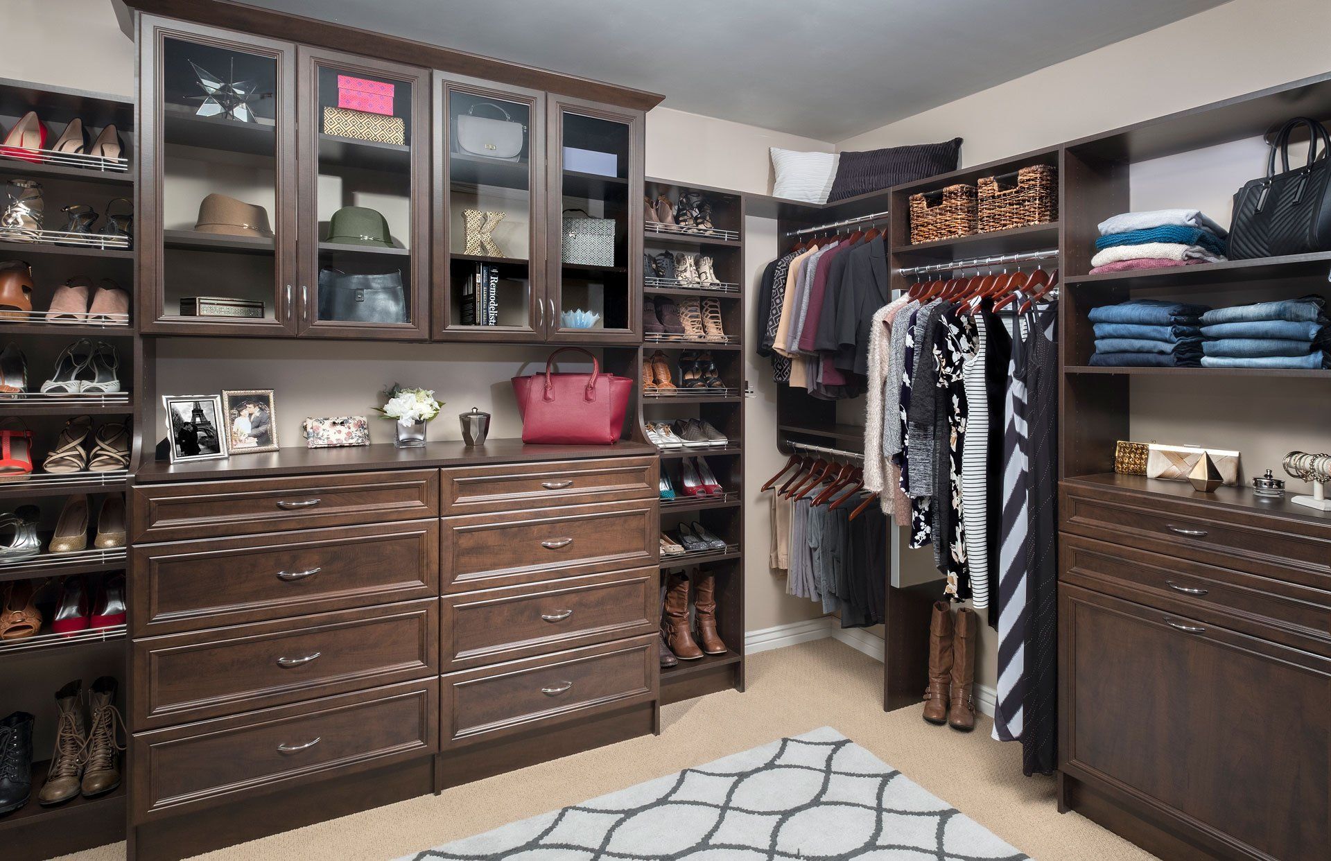 A walk in closet filled with lots of clothes and shoes.
