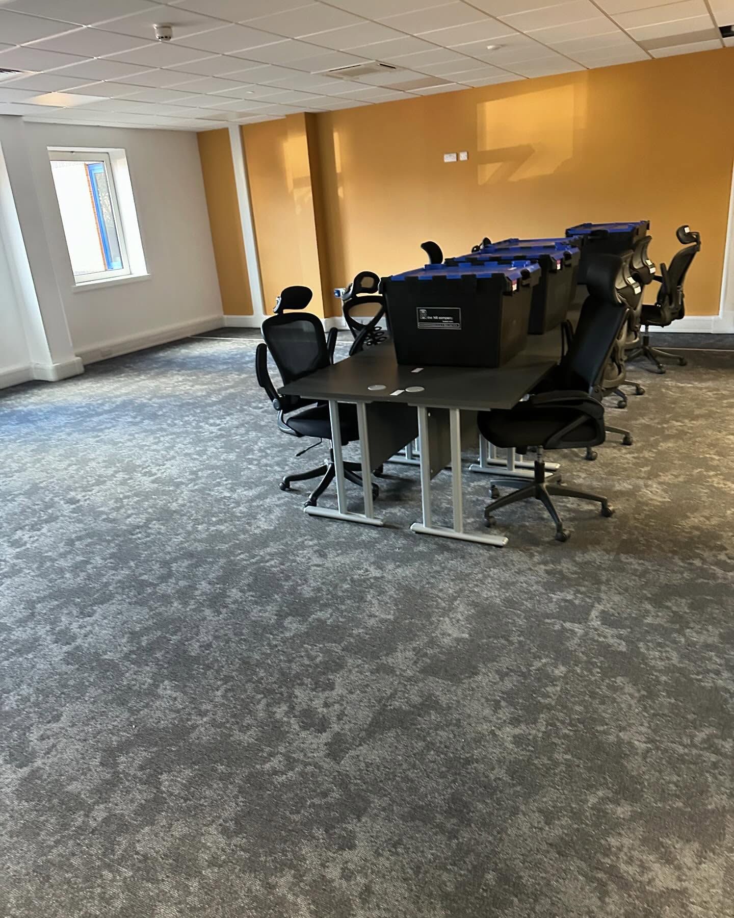 A room with a lot of chairs and tables in it.