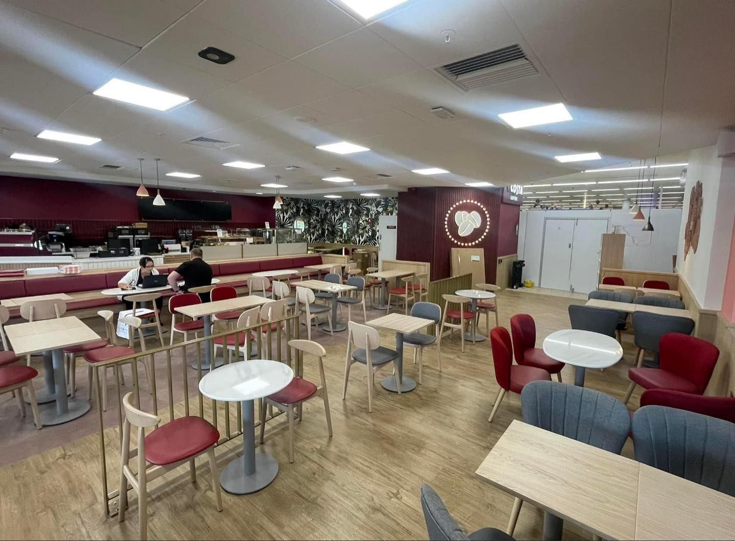 A large room filled with tables and chairs in a restaurant.