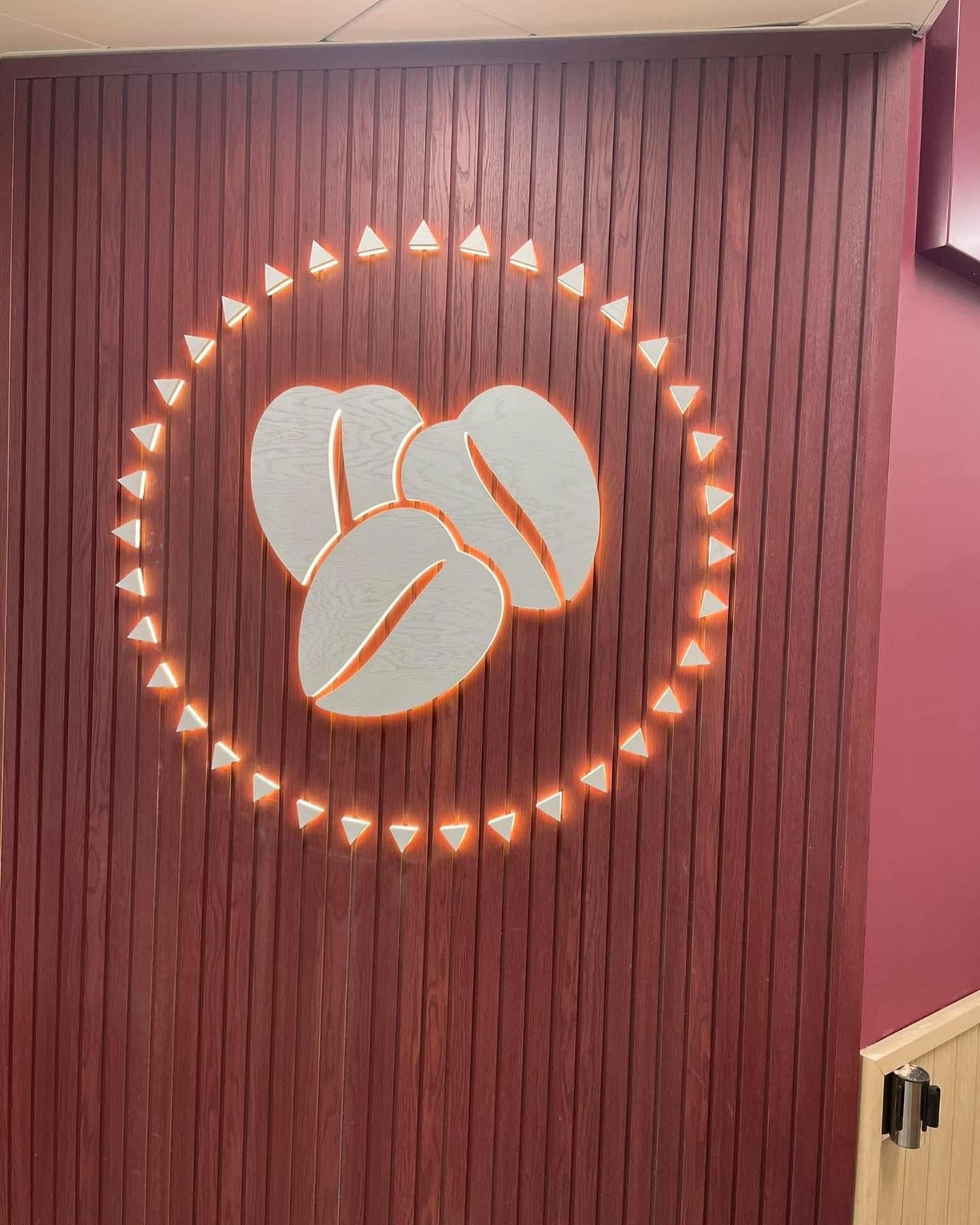 A picture of a coffee bean on a wooden wall.