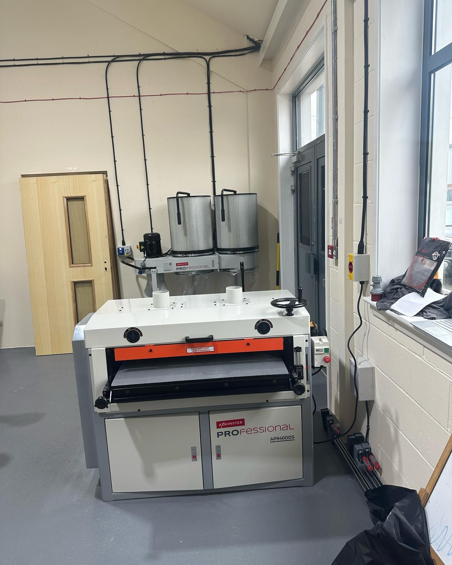 A machine is sitting in a room next to a window.