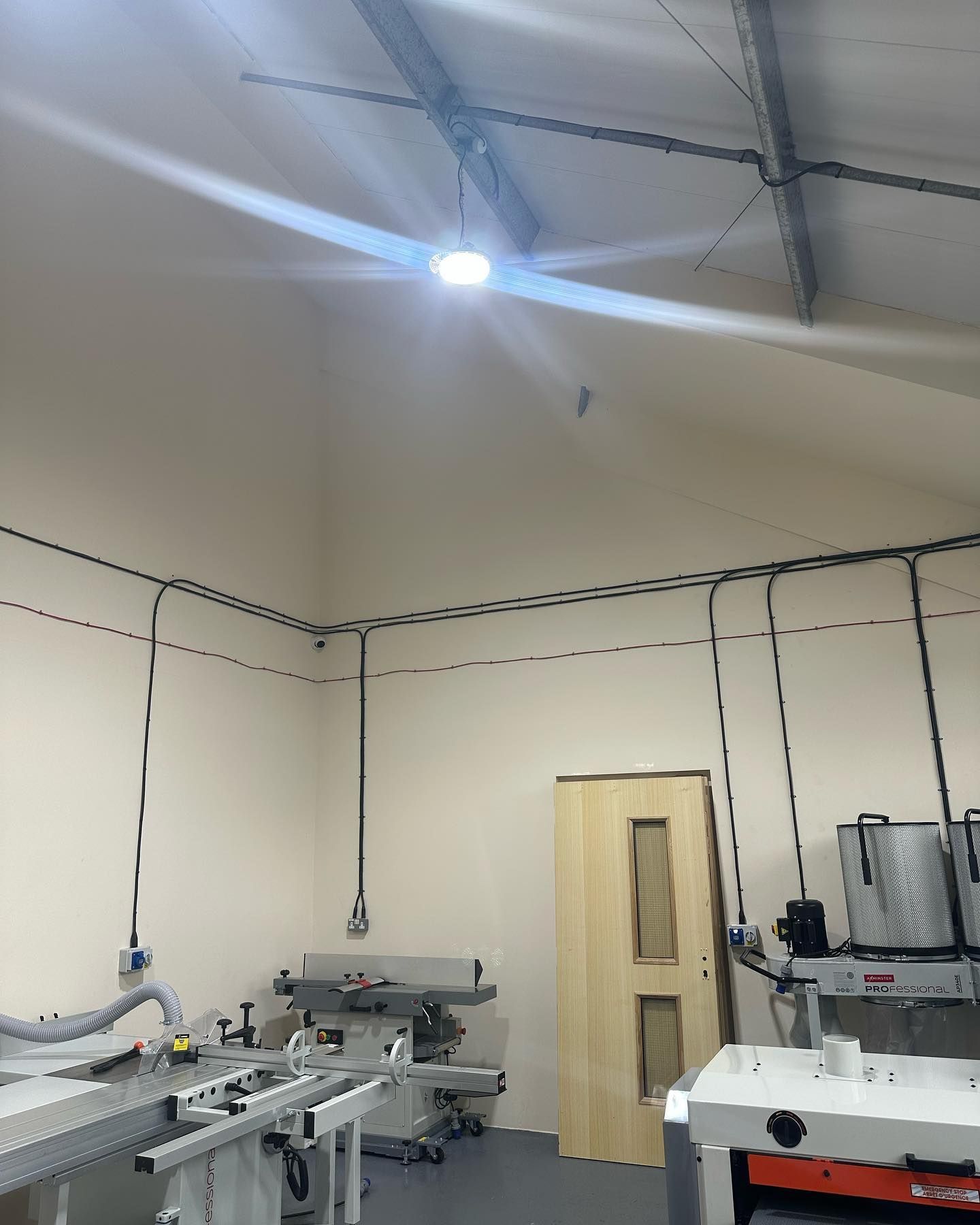 A room with a lot of machinery and a light on the ceiling