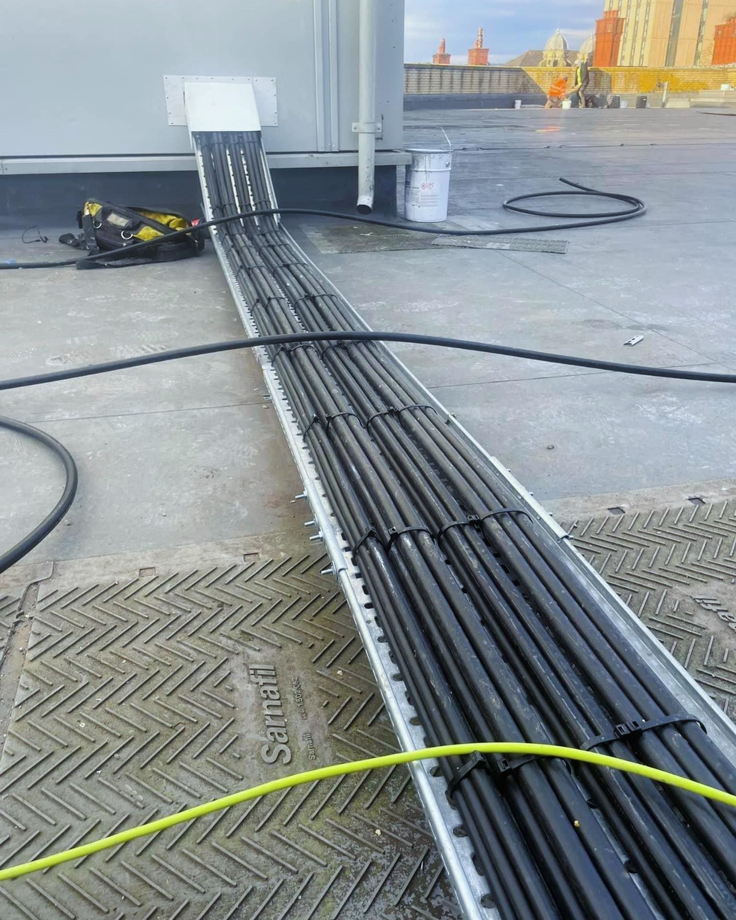 A bunch of electrical wires are laying on the ground