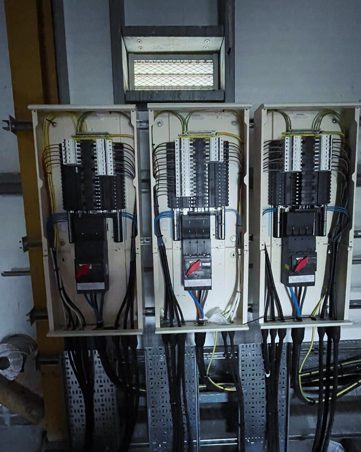 Three electrical boxes with wires coming out of them