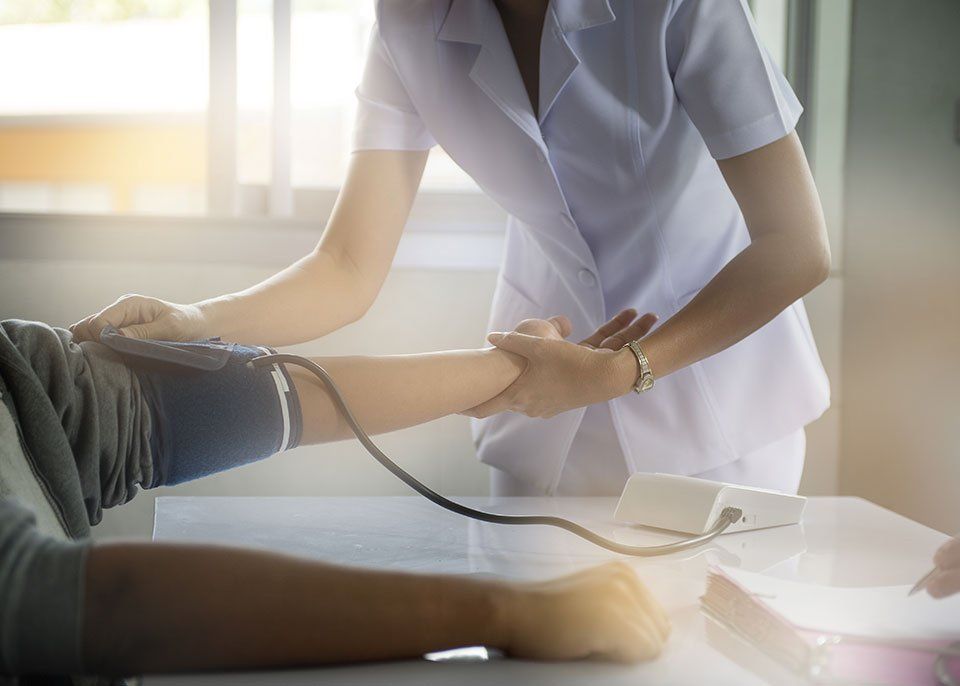 nurse checking patient Blood pressure