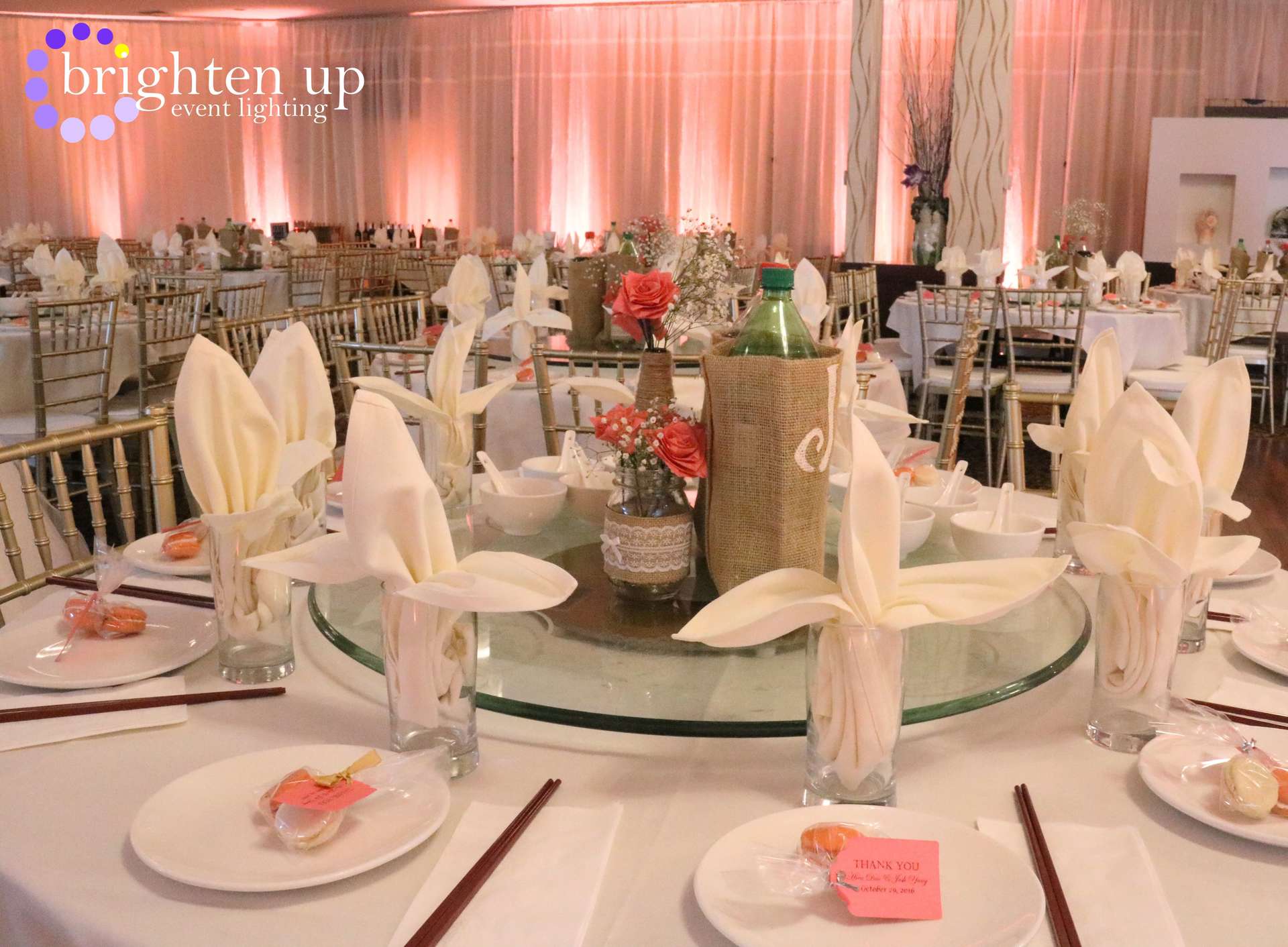 A large room with tables and chairs set up for a wedding reception.