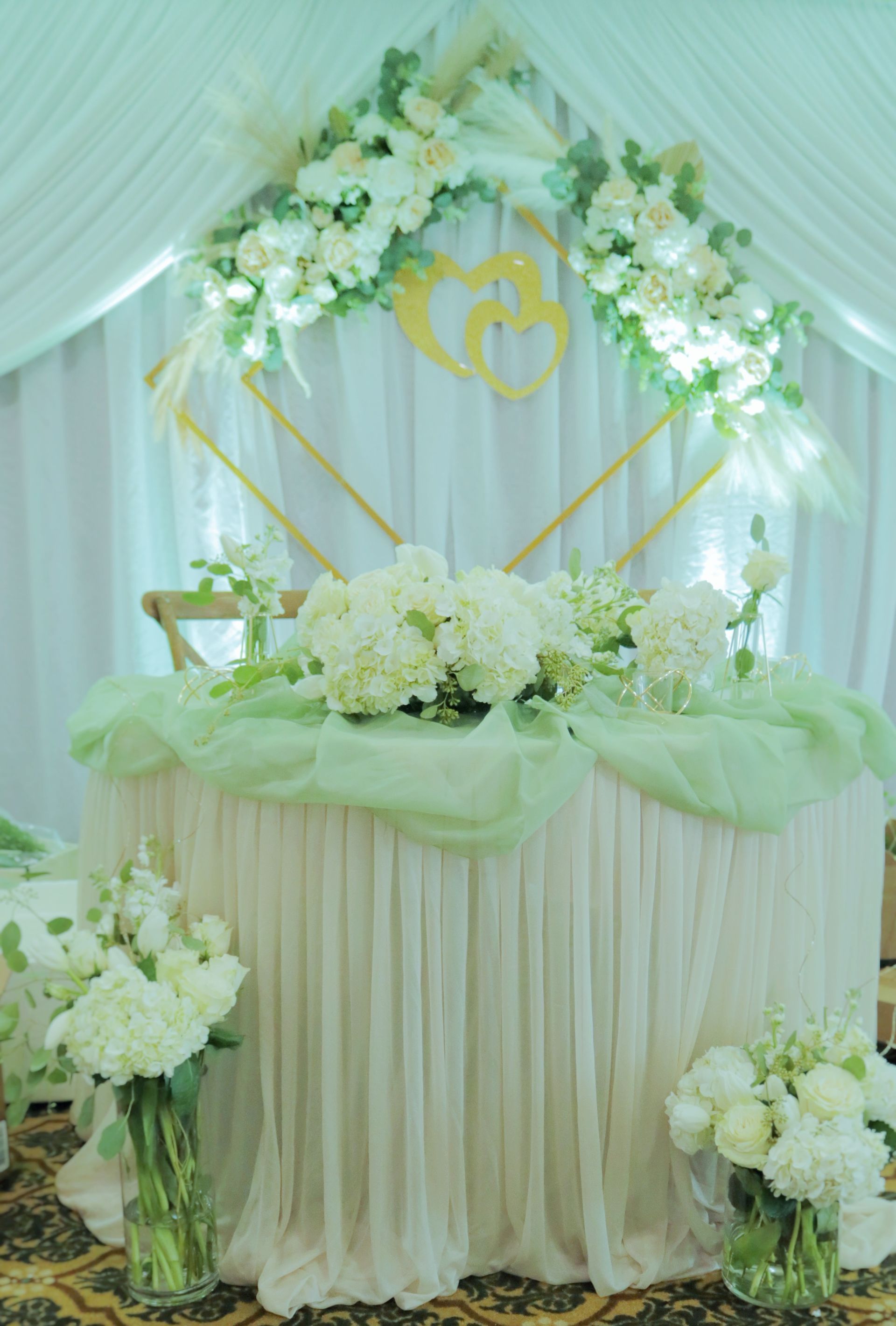 A table with flowers on it and a heart in the background.