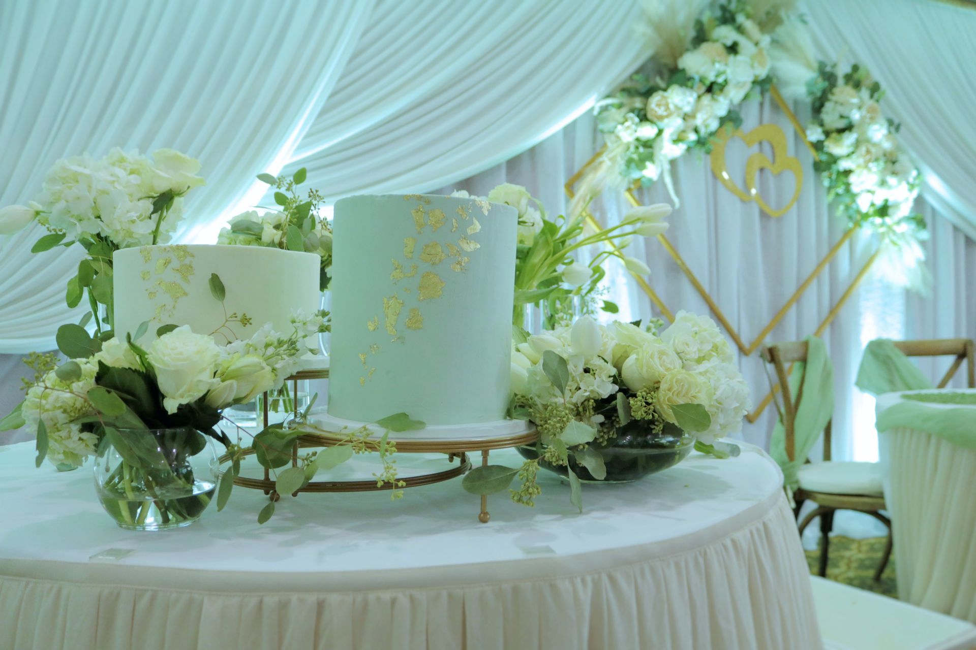 A wedding cake is sitting on top of a table decorated with flowers.