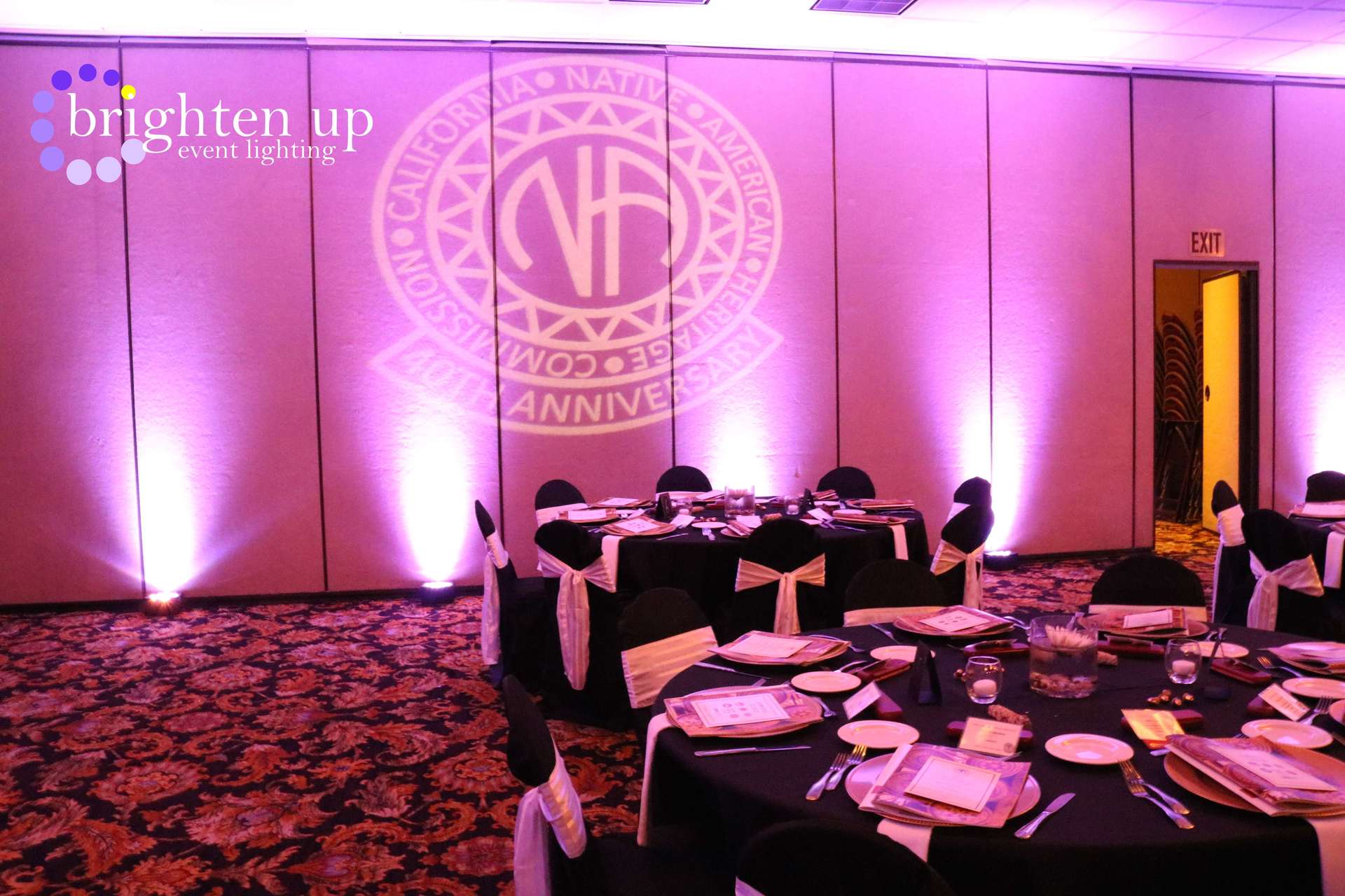 A room with tables and chairs and a nf logo on the wall