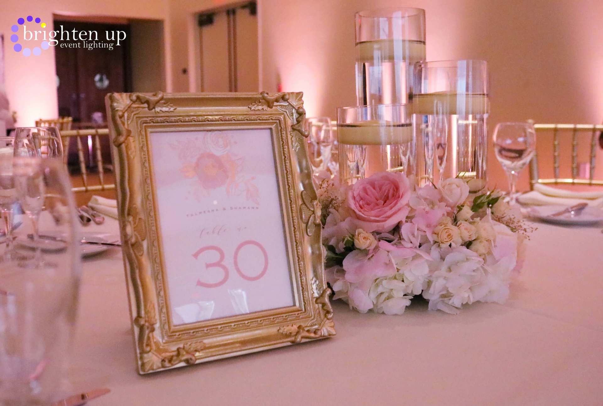 A table with a table number and flowers on it.