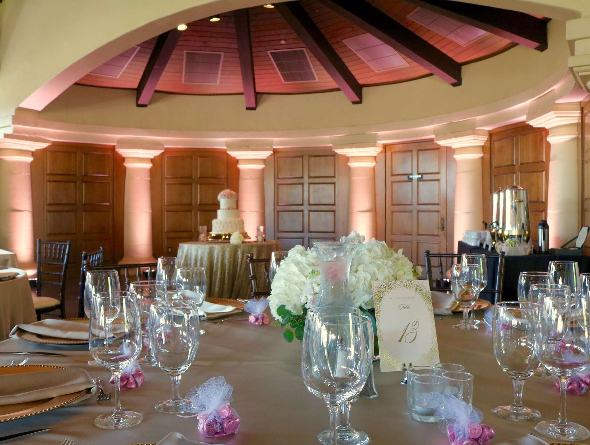 A table with a vase of flowers and a table number 13