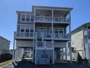 A large white house with a lot of windows and balconies.