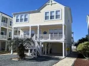 A large white house with a lot of windows and a porch.