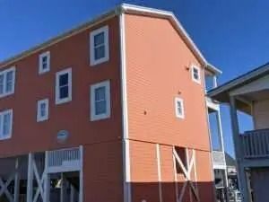 A large orange building with a blue sky in the background.