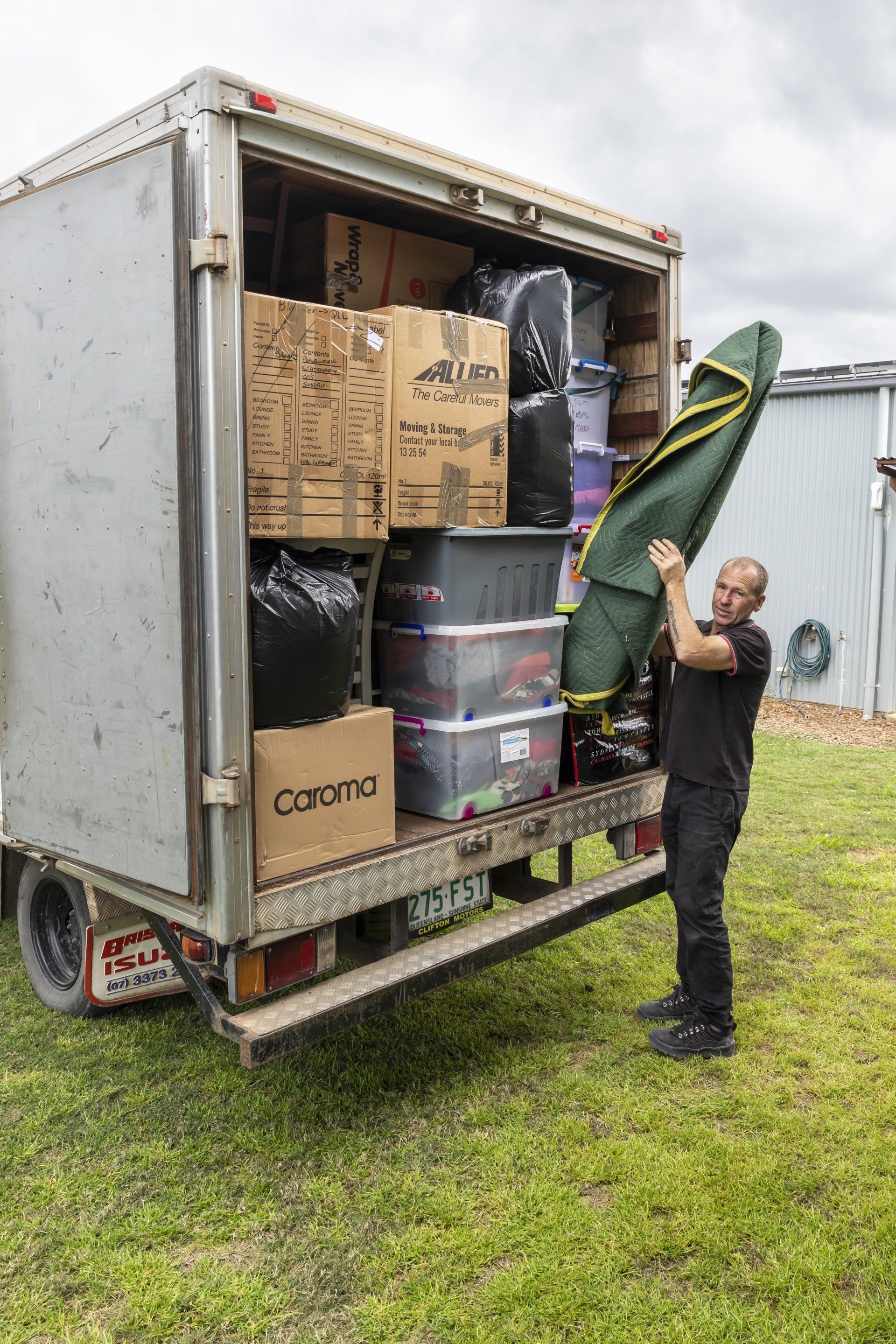 Worker Unloading Truck — Furniture Removals in Glenwood, QLD