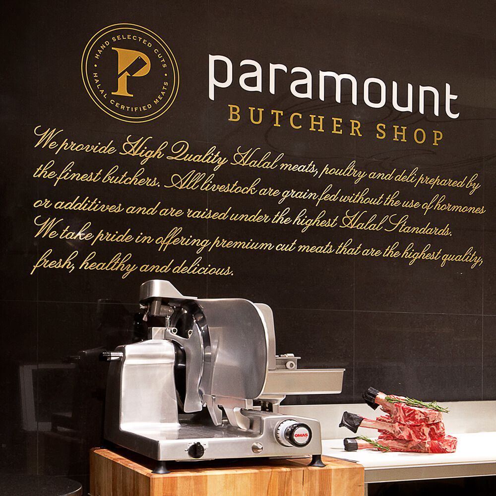 A paramount butcher shop sign with a meat slicer in front of it