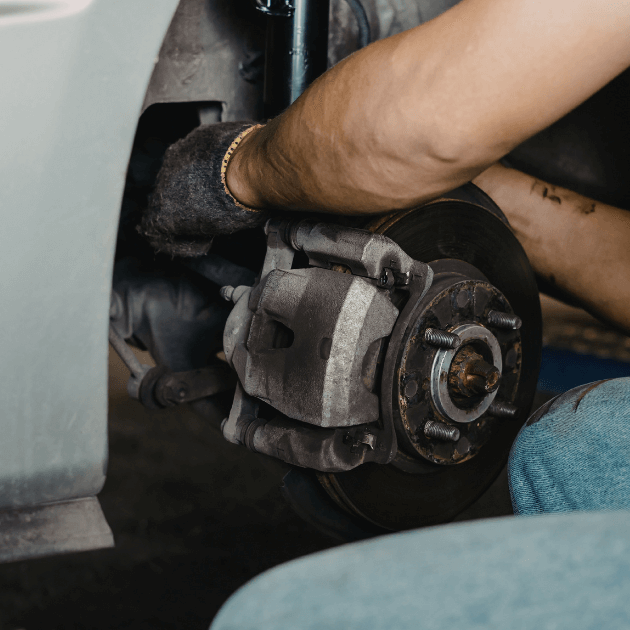 a mechanic fixing brakes on a car
