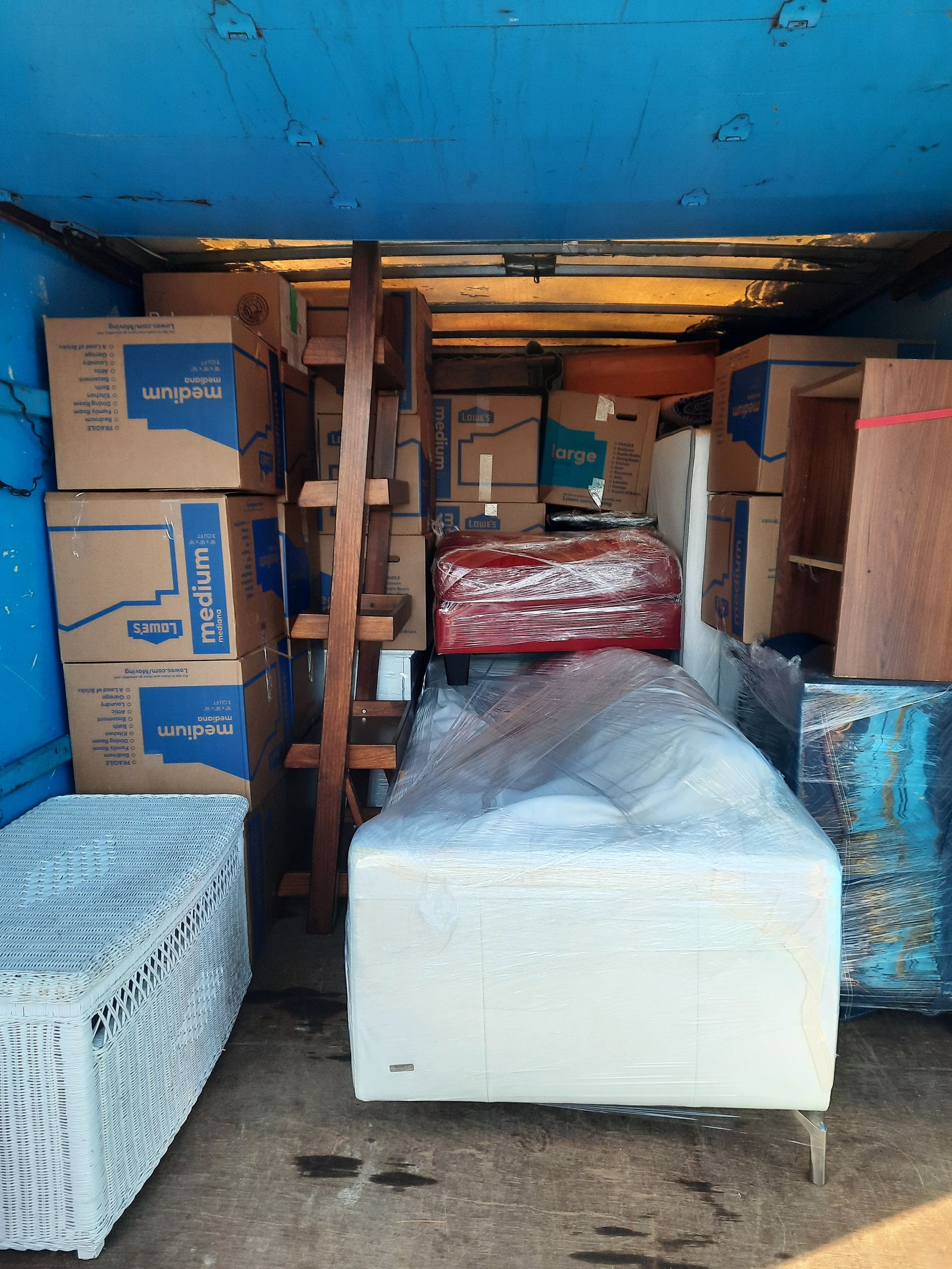 A truck filled with boxes and a bed