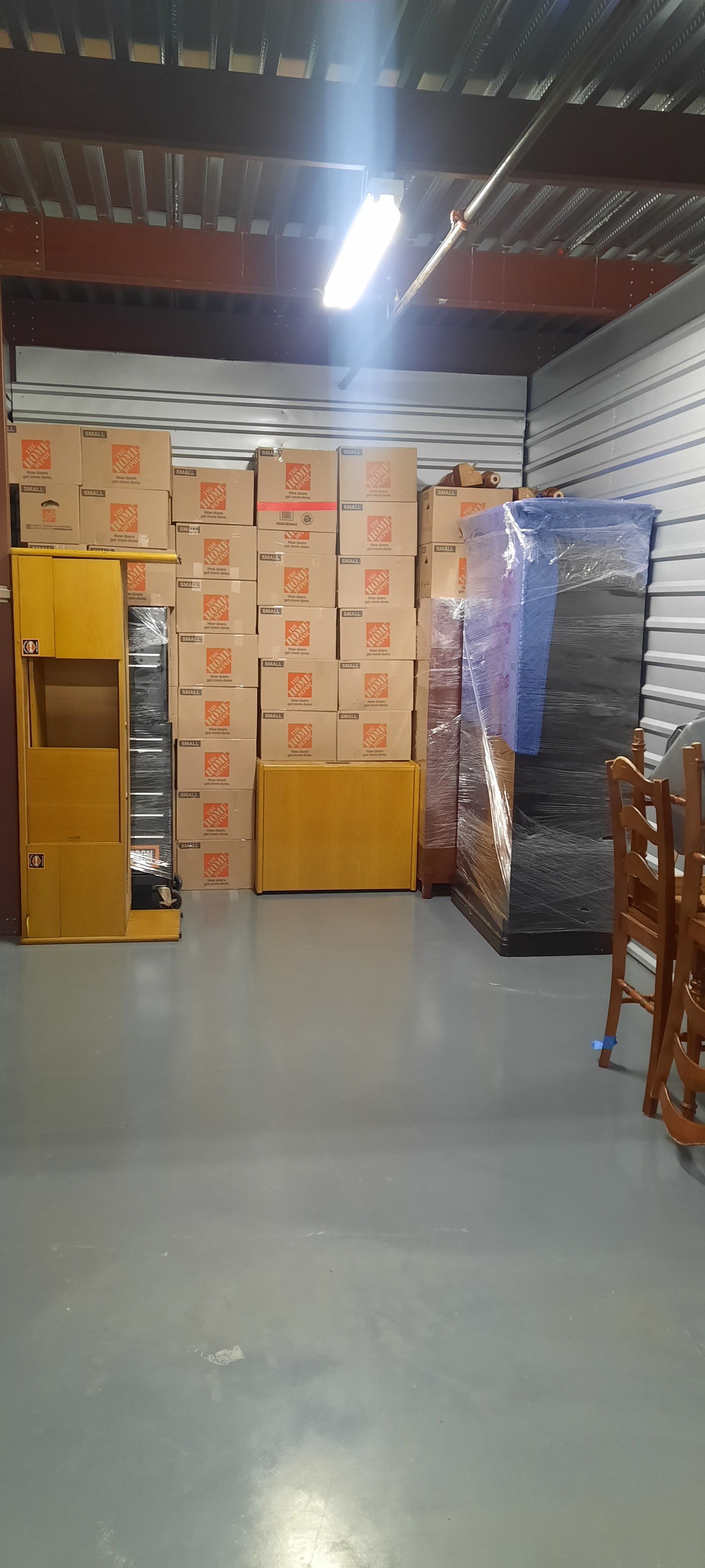 A warehouse filled with lots of boxes and chairs.