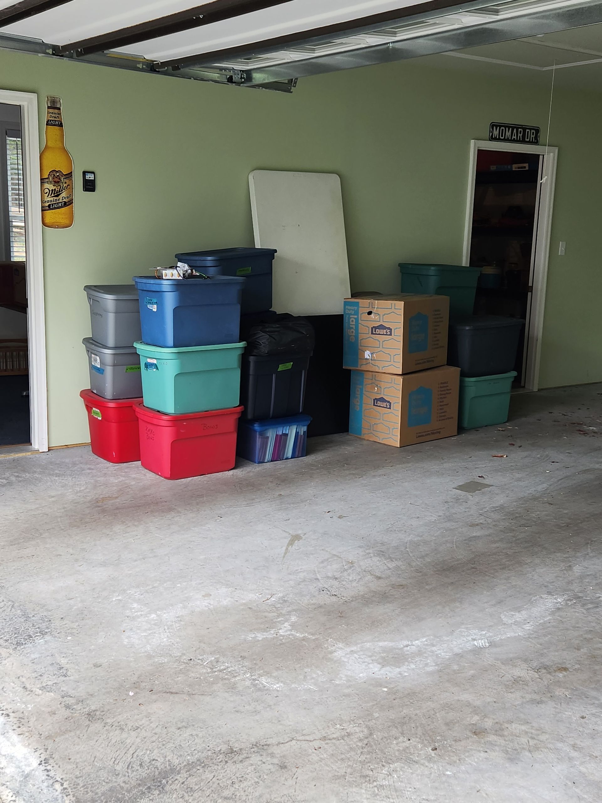 A bunch of boxes are stacked on top of each other in a garage