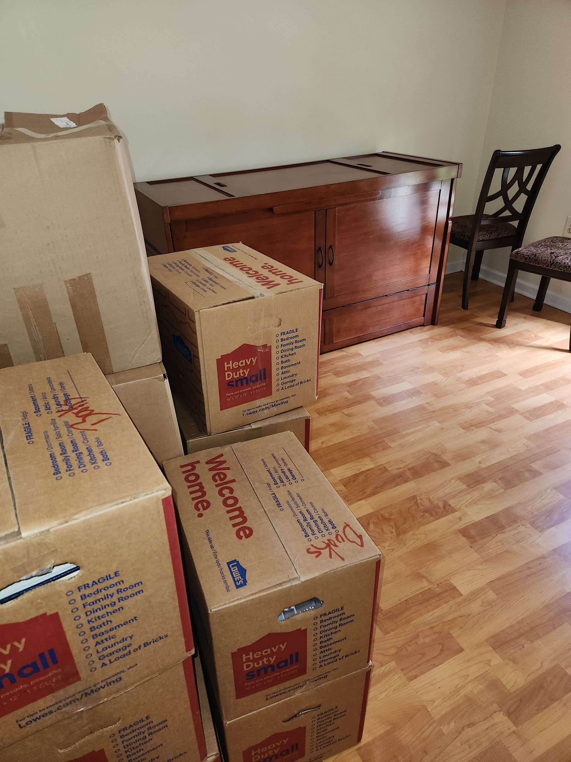 A room filled with moving boxes and a wooden chest