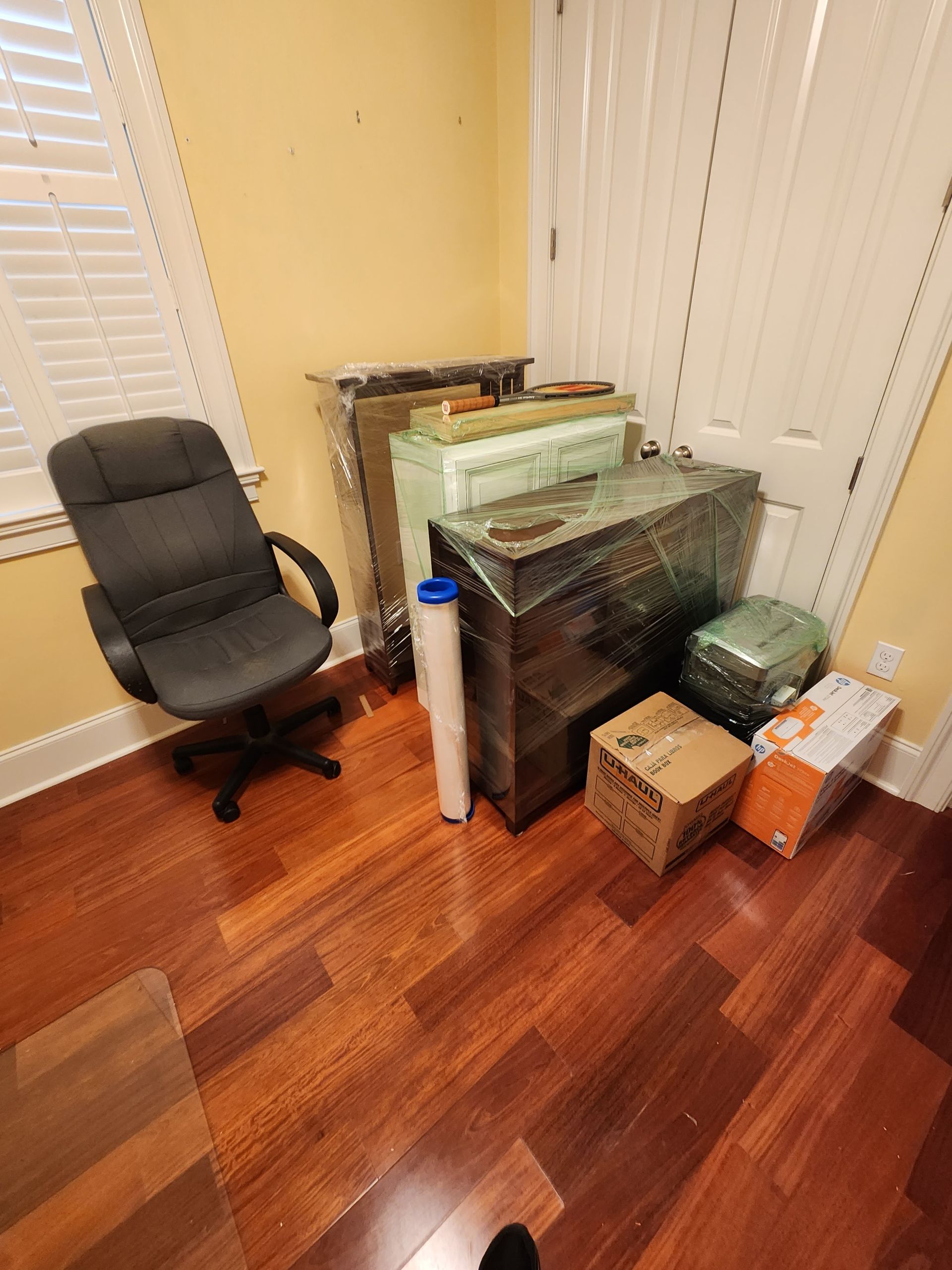 A room with a chair and boxes on the floor