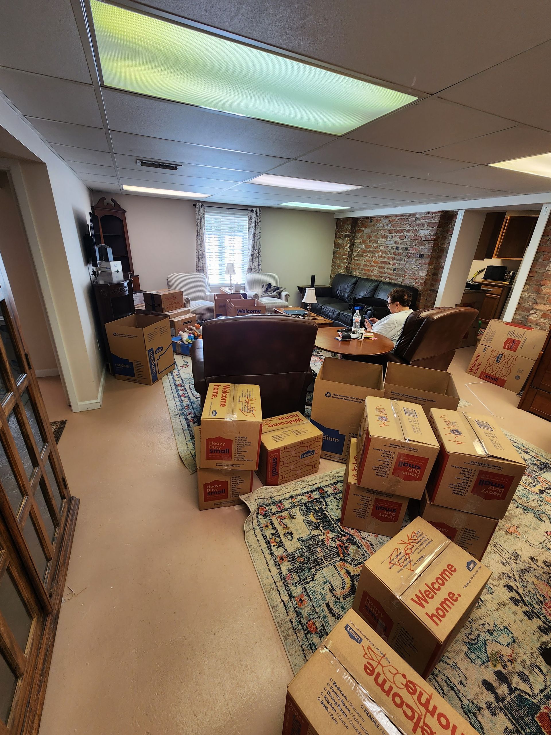A living room filled with boxes and a couch.
