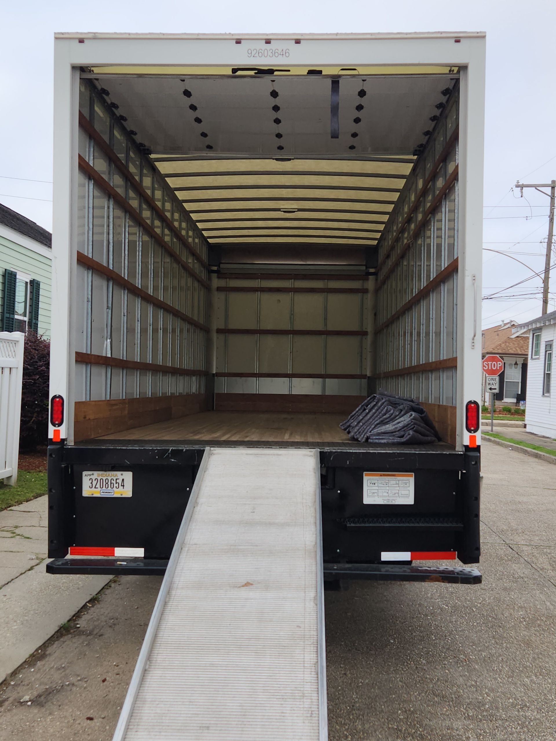 The back of a moving truck with a ramp attached to it