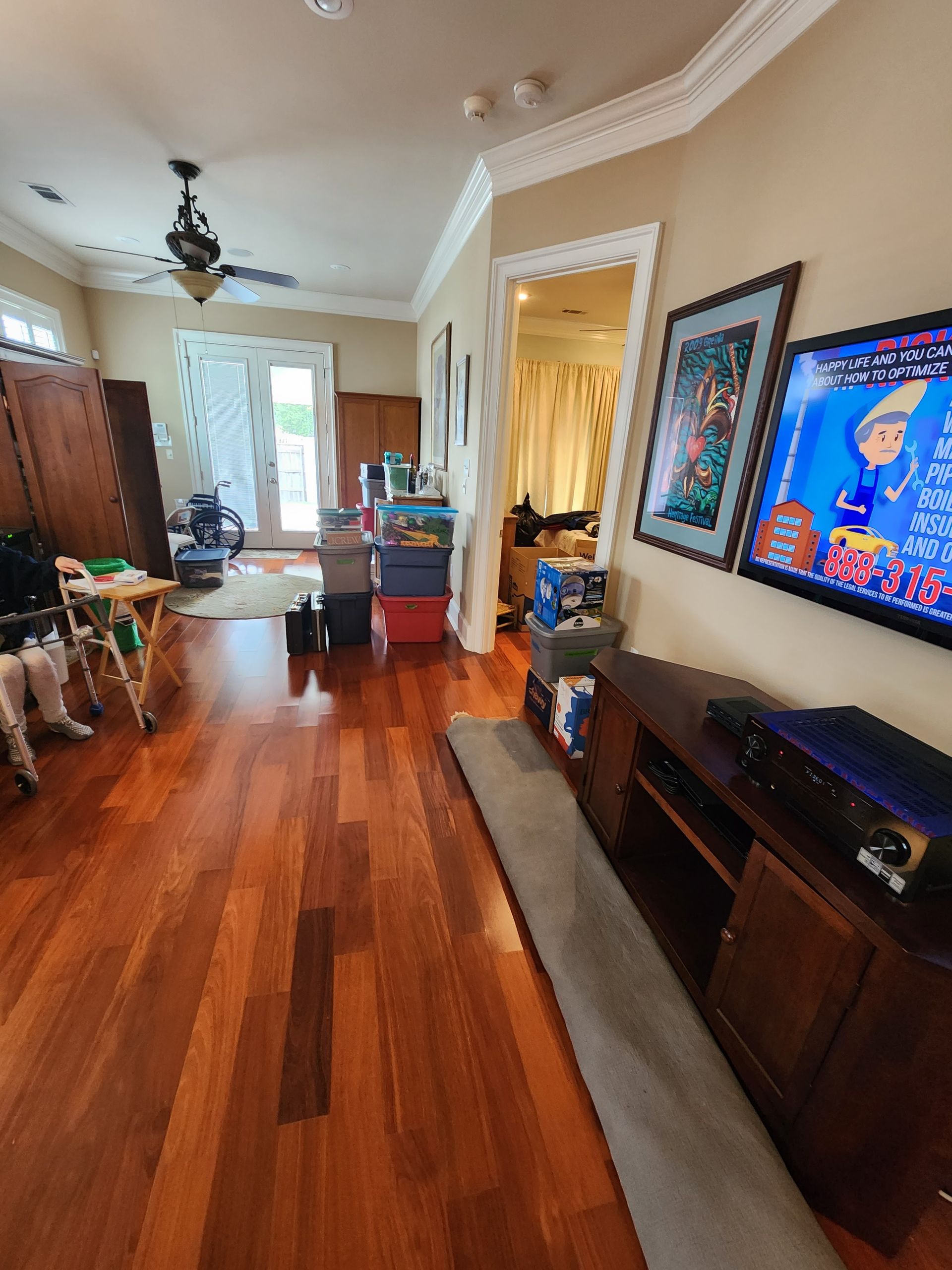 A living room with hardwood floors and a flat screen tv.