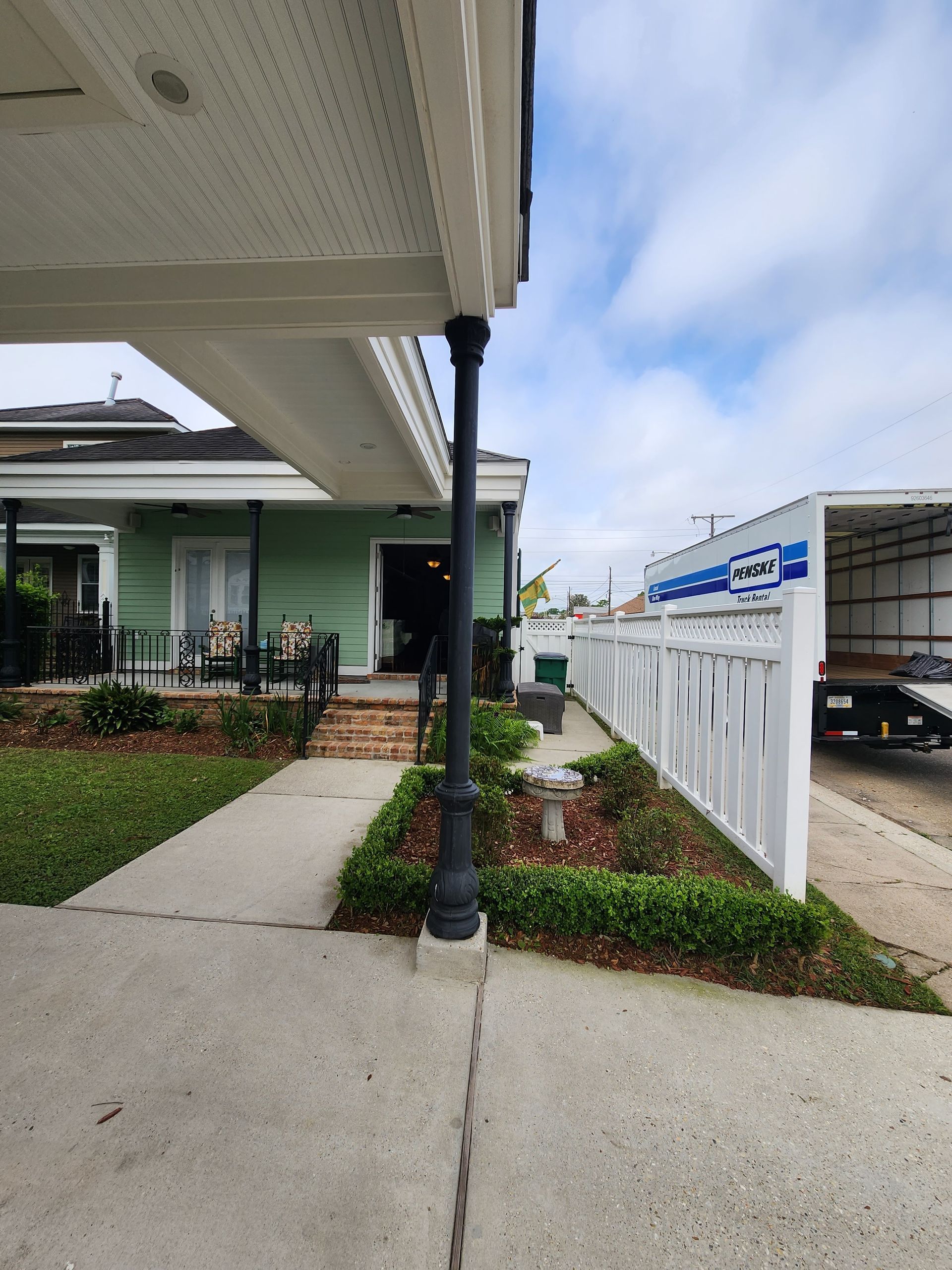 A white truck is parked in front of a house
