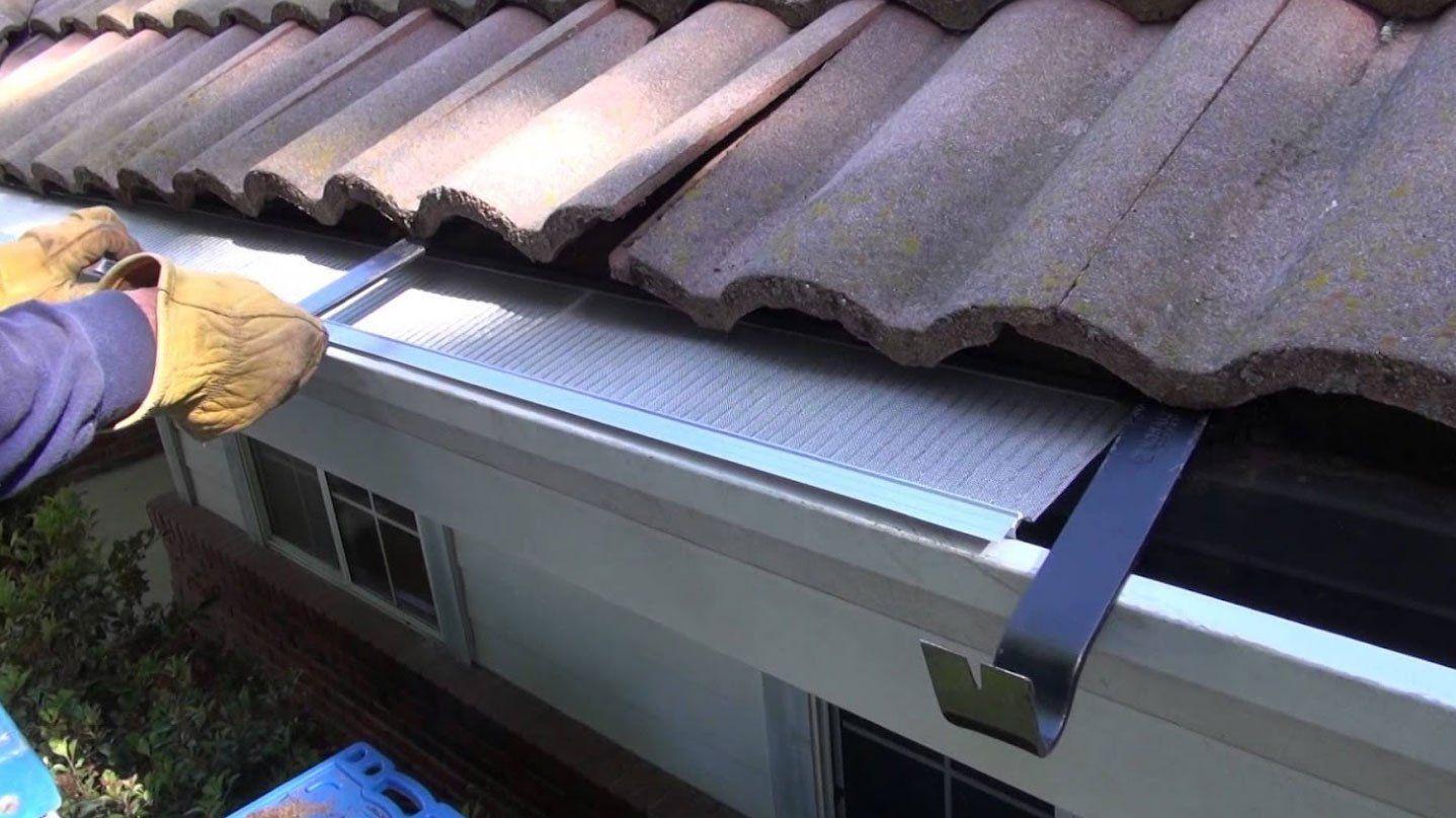 Man installing gutter — Savannah, GA — Professional Grade Gutters