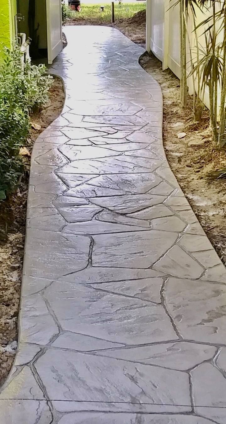 A patio with a shadow of a palm tree on it.