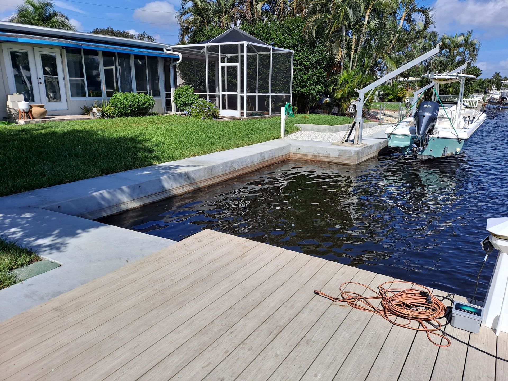 A boat is docked at a dock next to a house.
