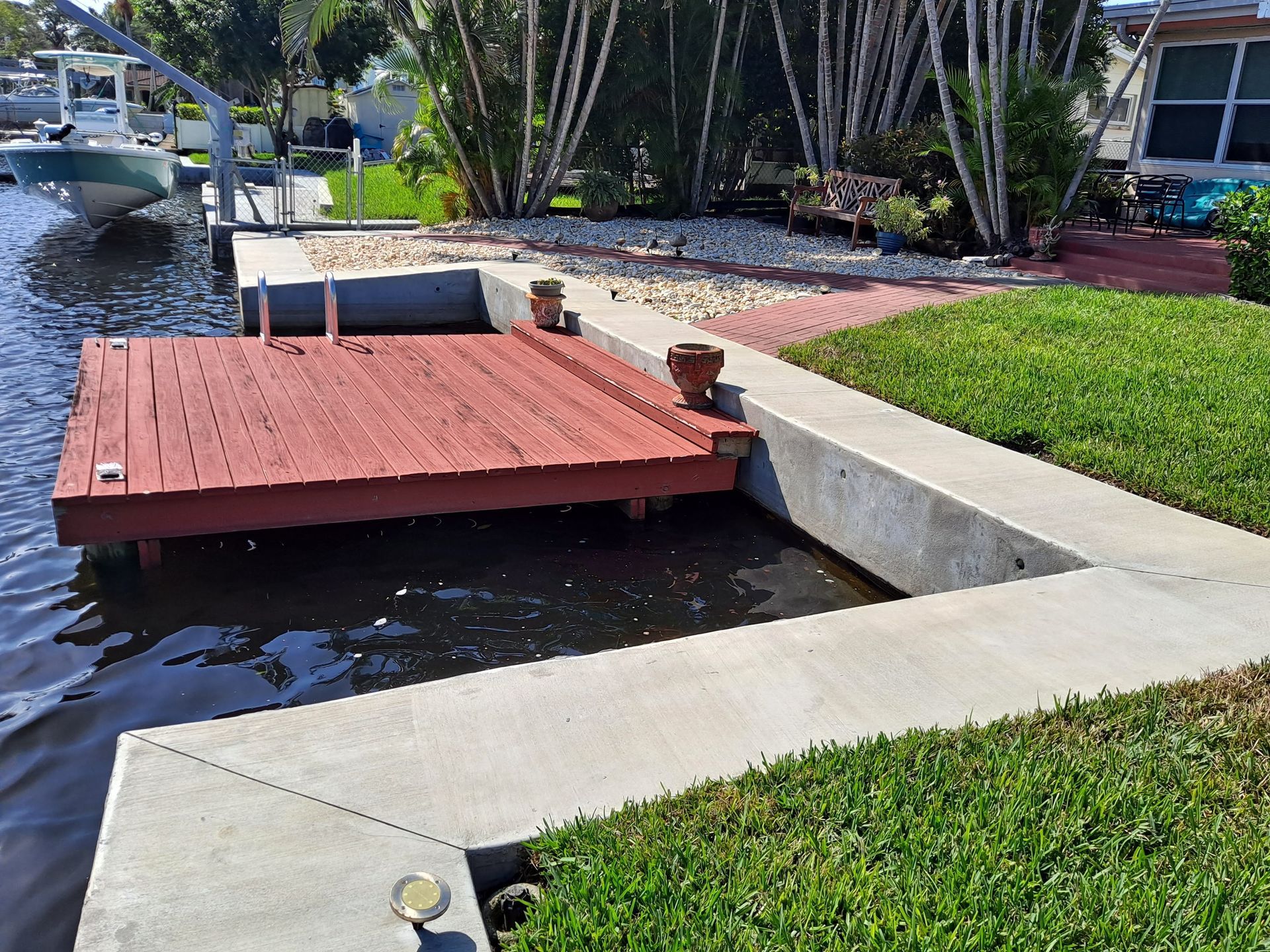 A boat is docked at a dock next to a house