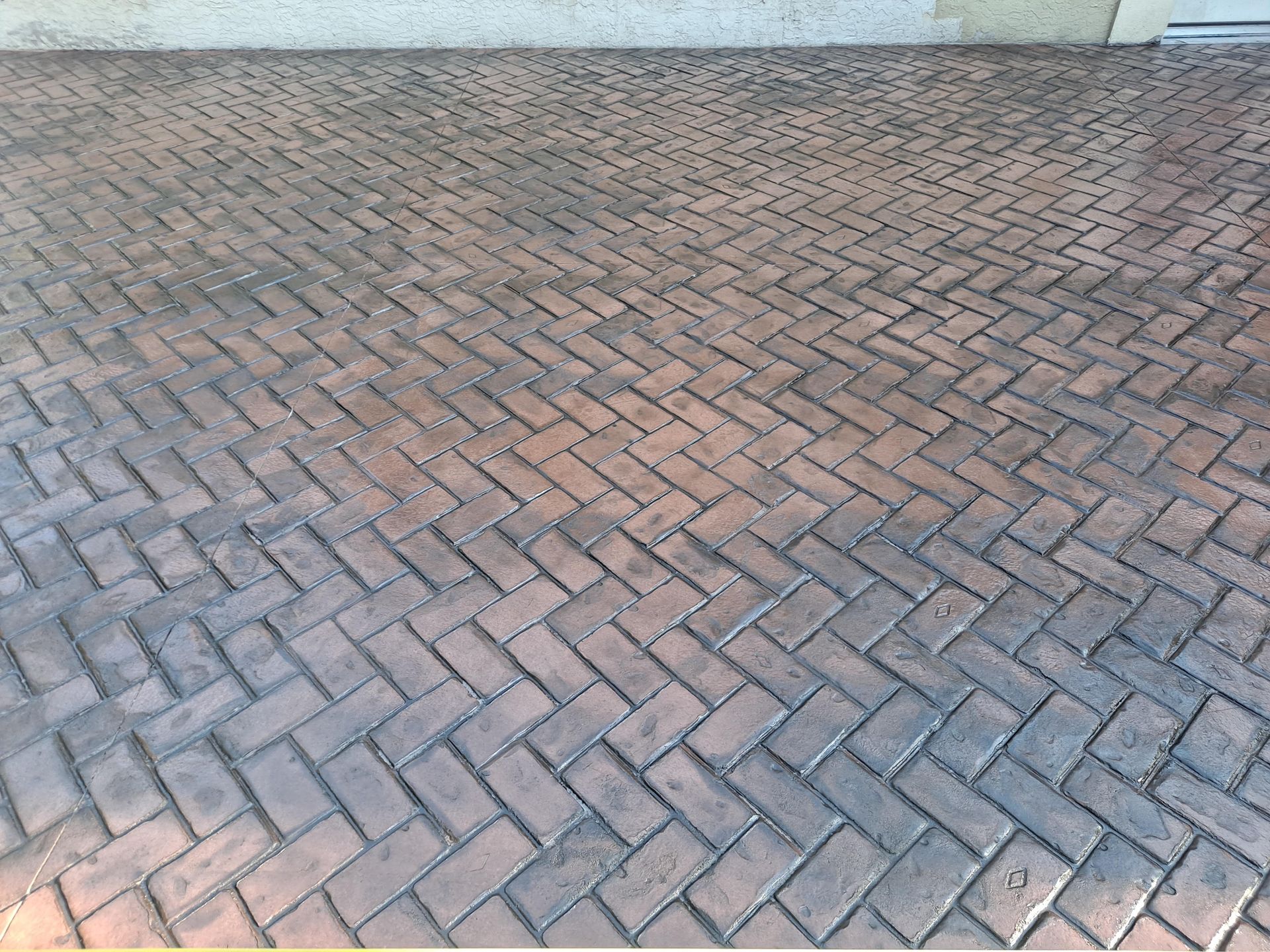 A brick floor with a herringbone pattern on it