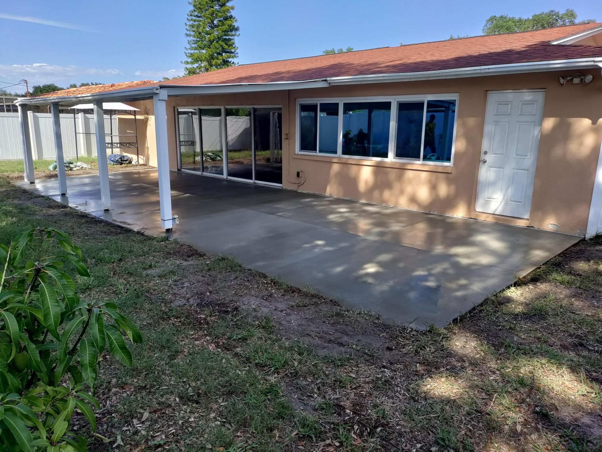 A house with a covered patio in front of it.