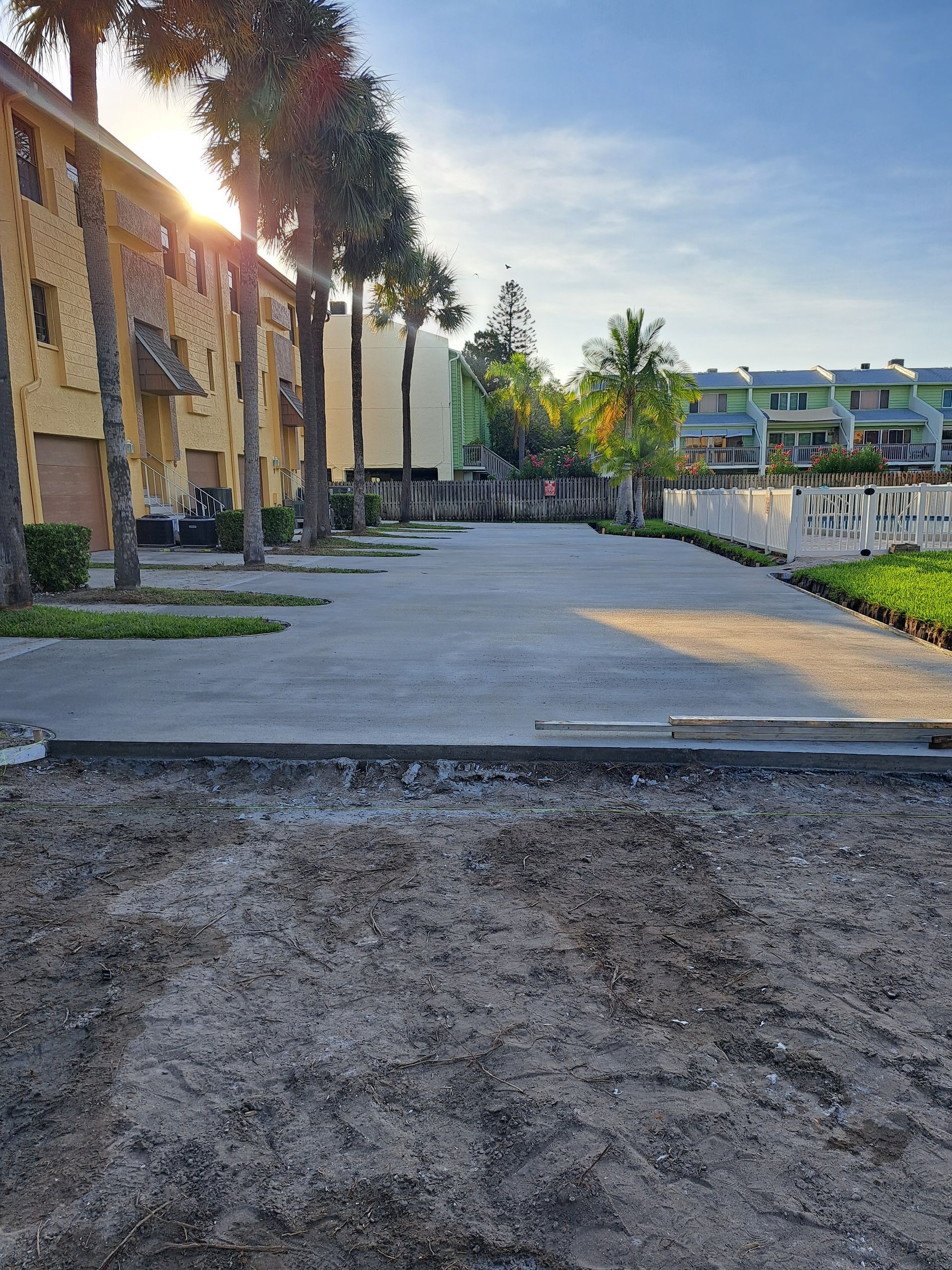 A concrete driveway is being built in front of a building.