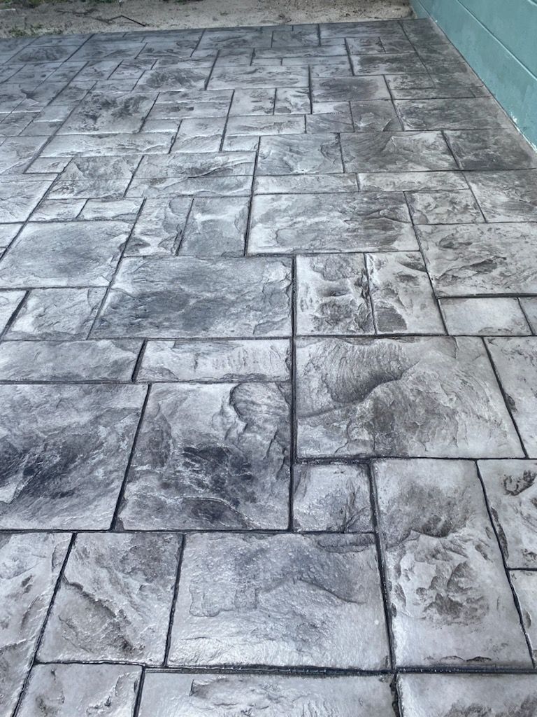 A black and white photo of a gray brick floor.