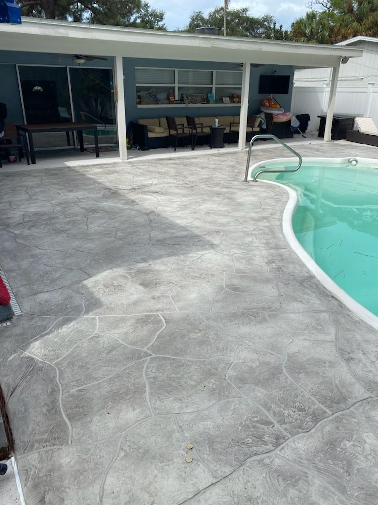 There is a swimming pool in the backyard of a house.