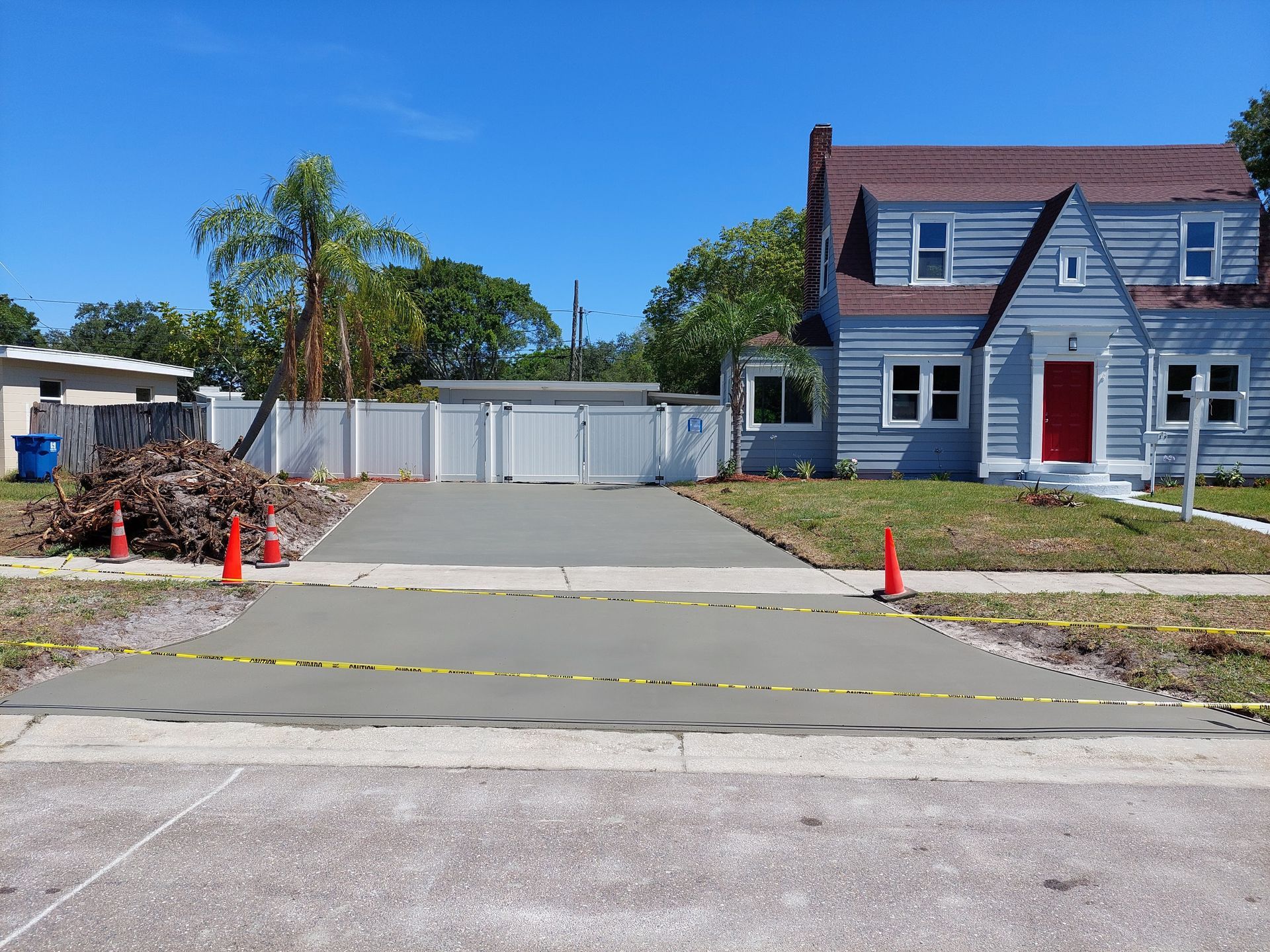 A house with a concrete driveway in front of it