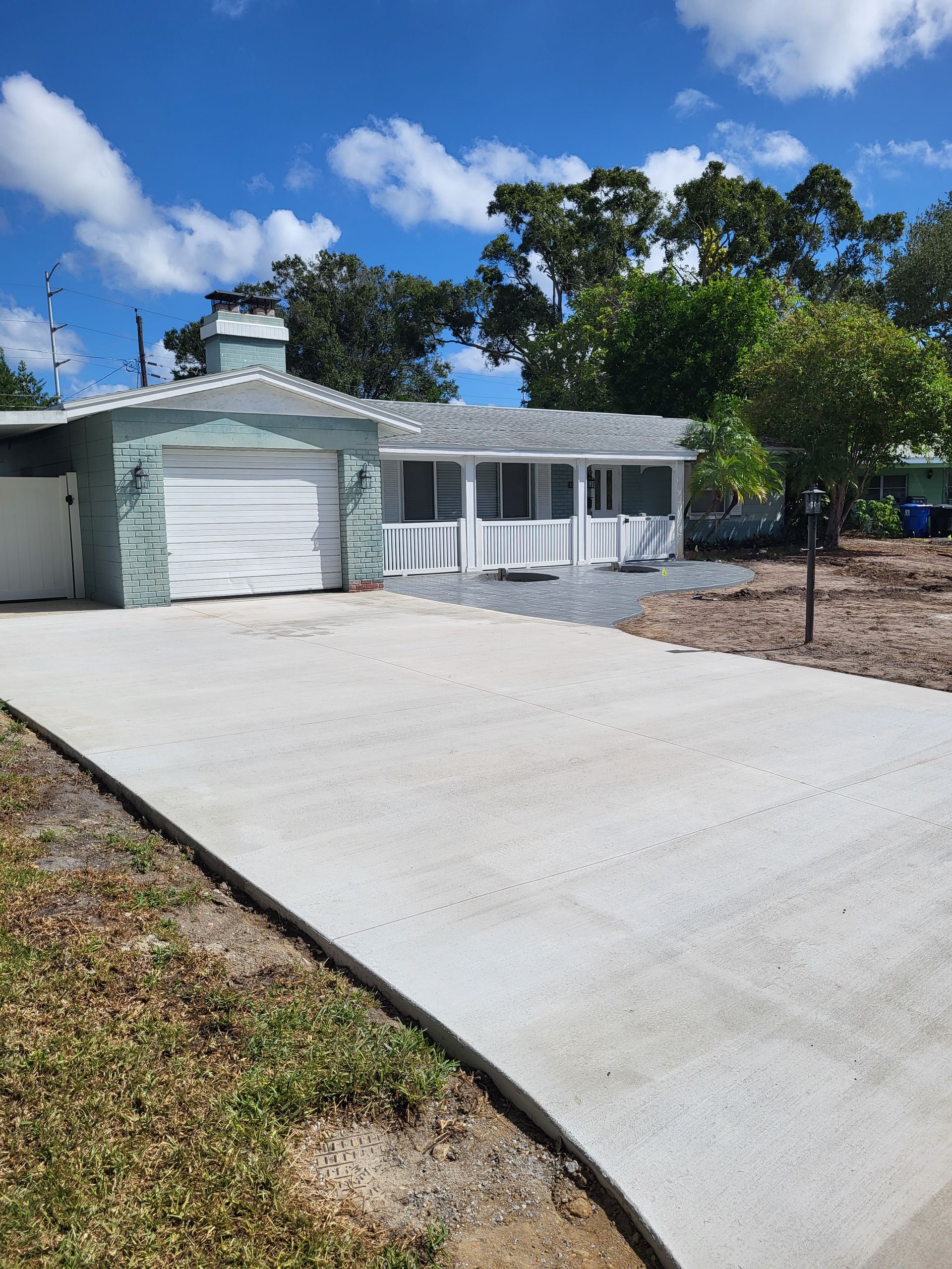 A house with a concrete driveway in front of it