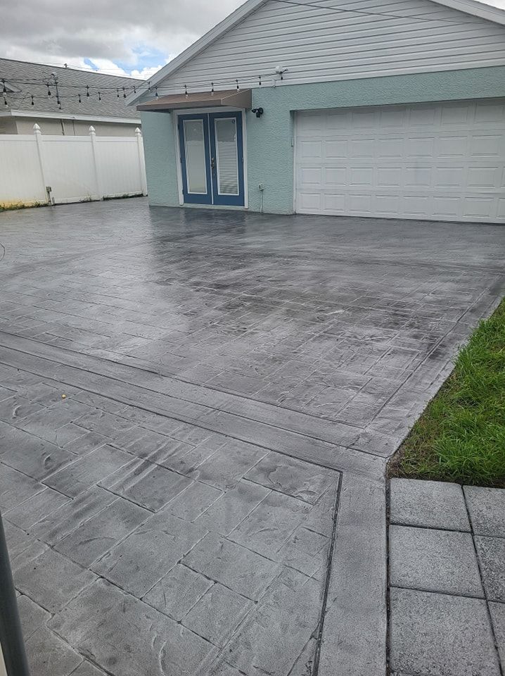 There is a concrete driveway in front of a house.