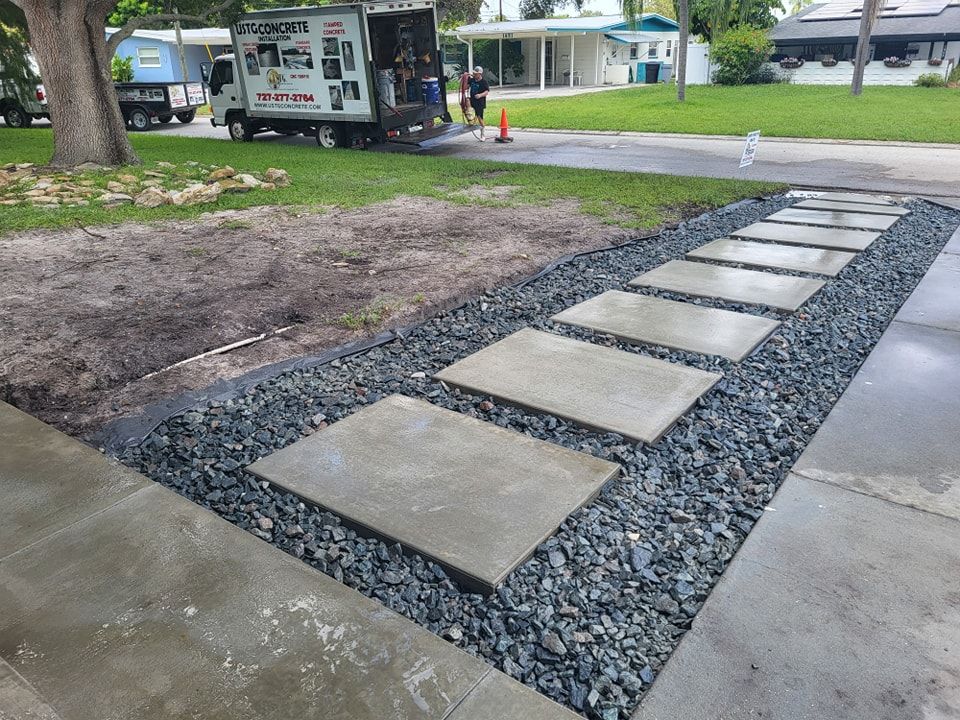 A concrete walkway with a truck in the background