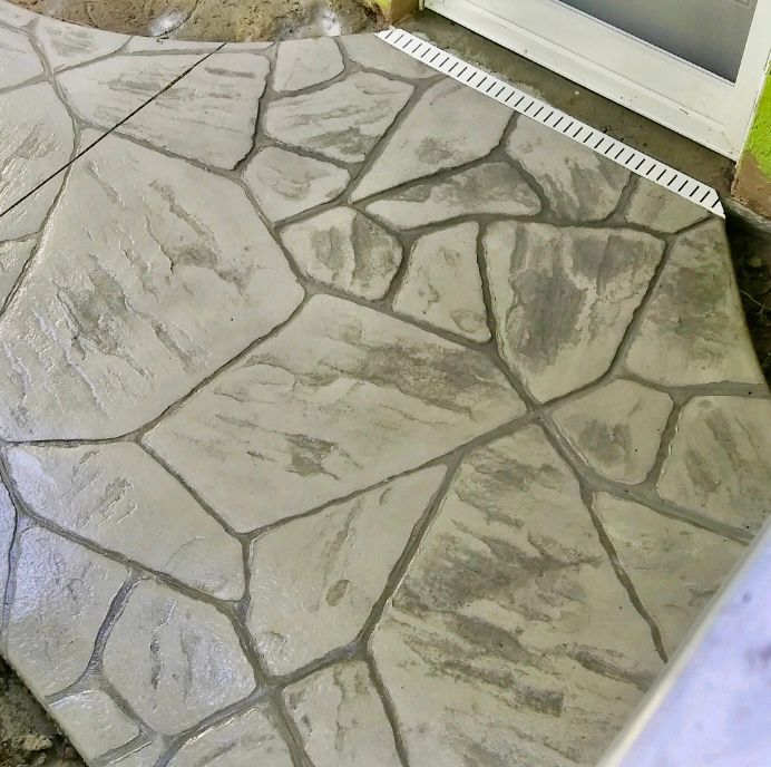 A concrete walkway that looks like a stone floor