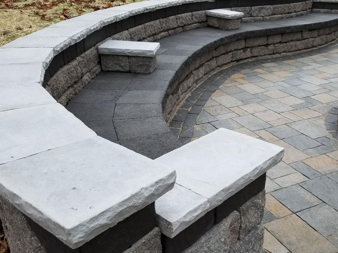 A brick wall with a curved bench in the middle of it