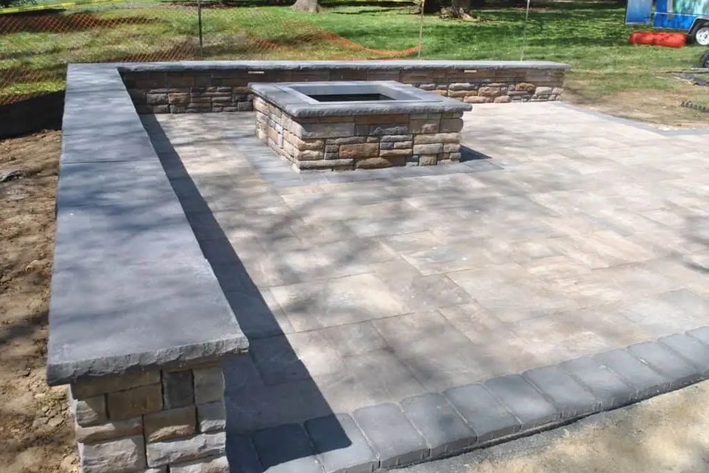 There is a fire pit in the middle of the patio.