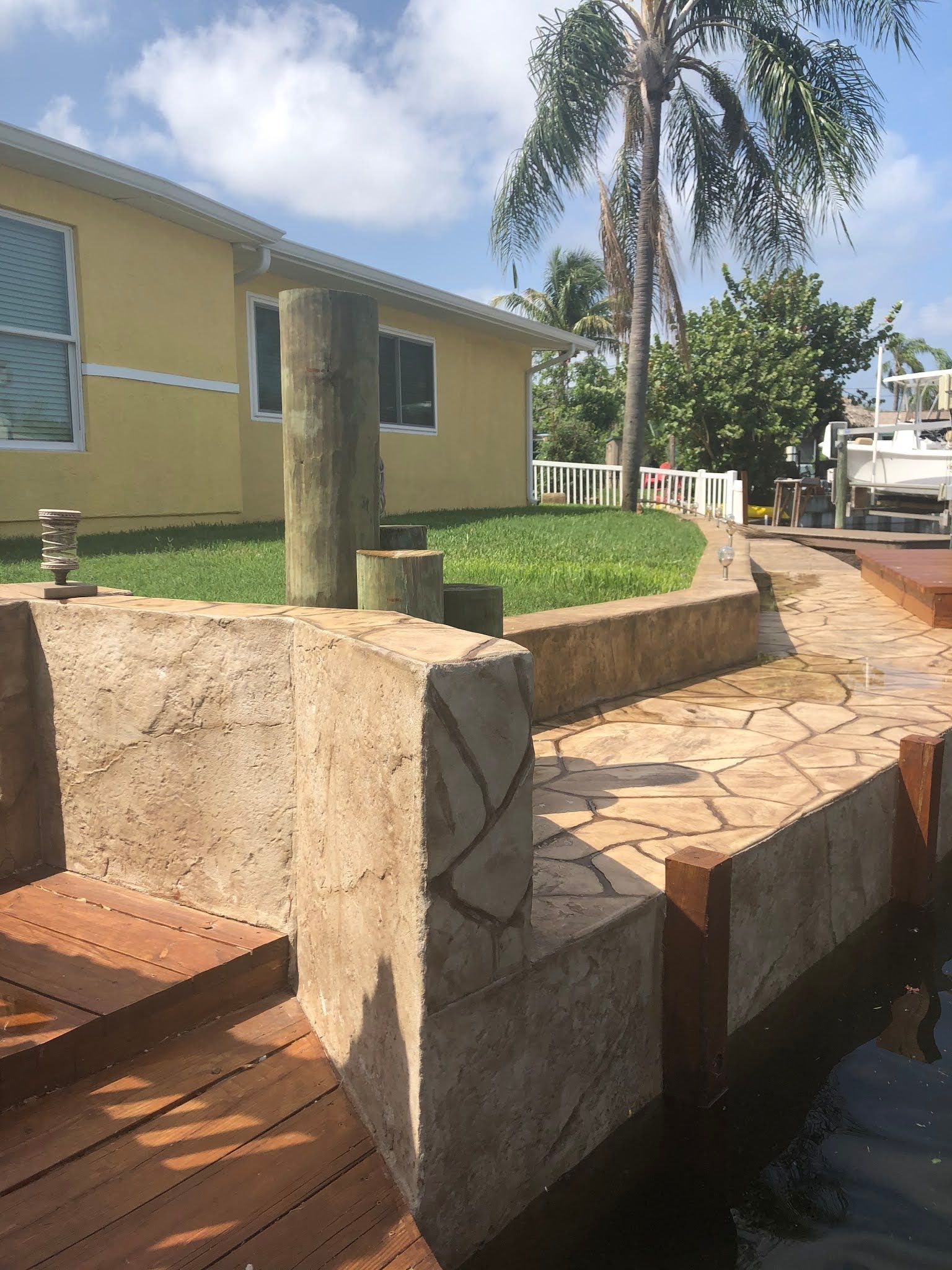 A yellow house is sitting next to a body of water.