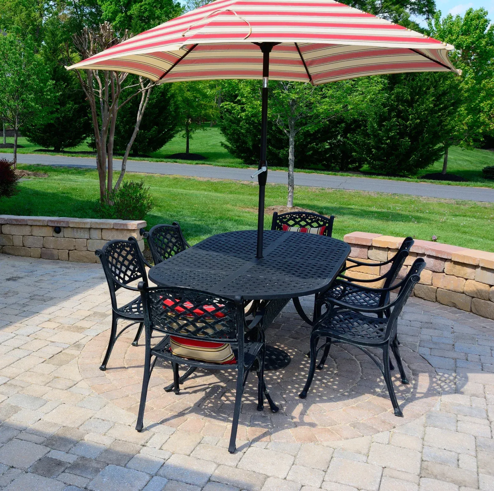 A table and chairs under an umbrella on a patio
