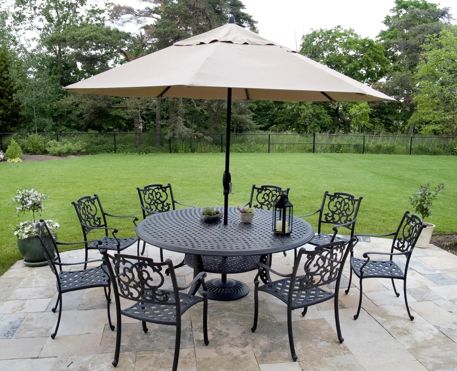A table and chairs under an umbrella on a patio