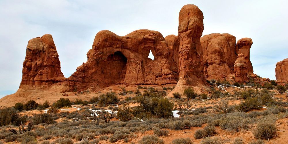 A large rock formation in the middle of a desert.